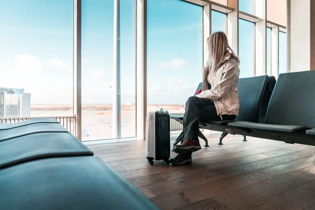 woman traveler waiting at icelandic airport picjumbo com